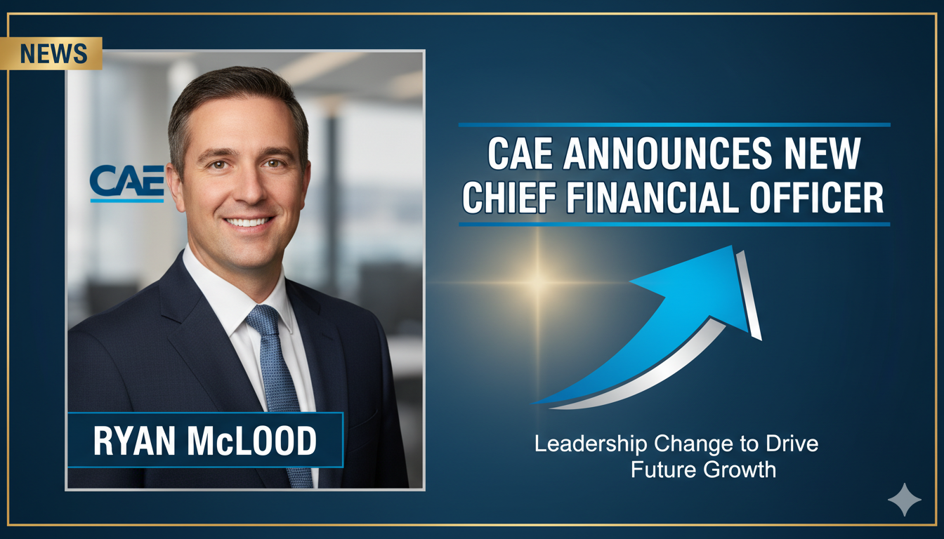 Professional portrait of Ryan McLeod in a business suit against a backdrop of aerospace simulation equipment.